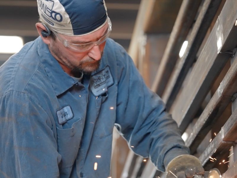 mid-city-steel-about-tough-job-team-man-using-handsaw-sparks-metal-safety-glasses-800x600