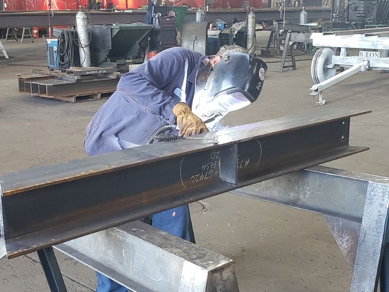 mid-city-steel-about-tough-job-team-worker-welding-short-metal-beam-800x600