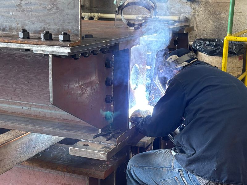 mid-city-steel-about-vision-mission-values-shop-worker-welding-mask-sparks-gloves-800x600