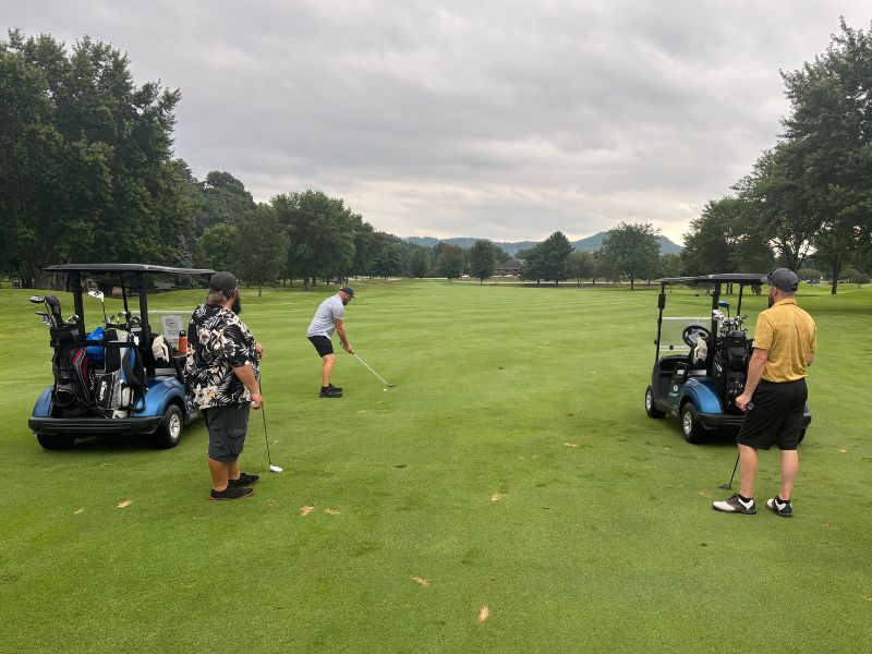 mid-city-steel-company-culture-golf-events-three-employees-green-work-event-MCS-carts-800x600
