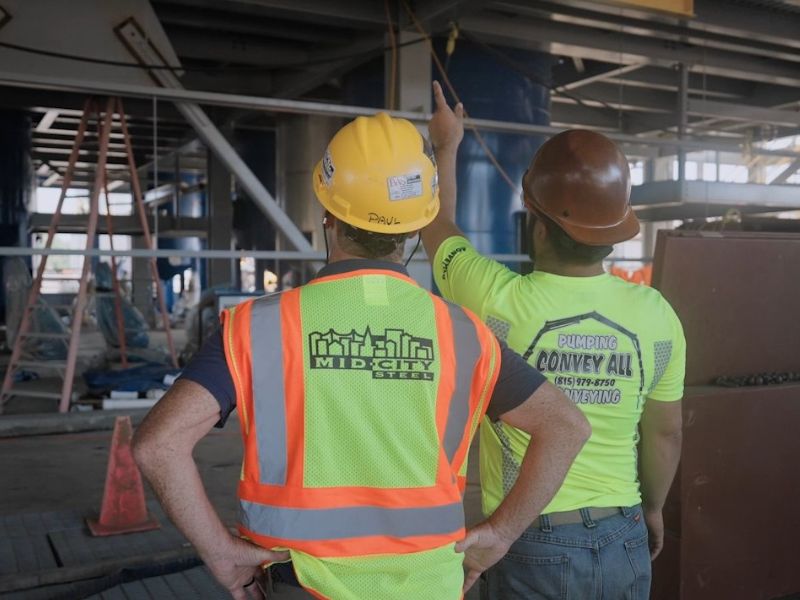 mid-city-steel-toll-and-outsource-solutions-two-workers-convey-all-800x600