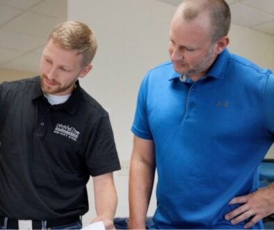 Two Mid-City Steel team members reviewing project and pre-fabrication plans together in an office.